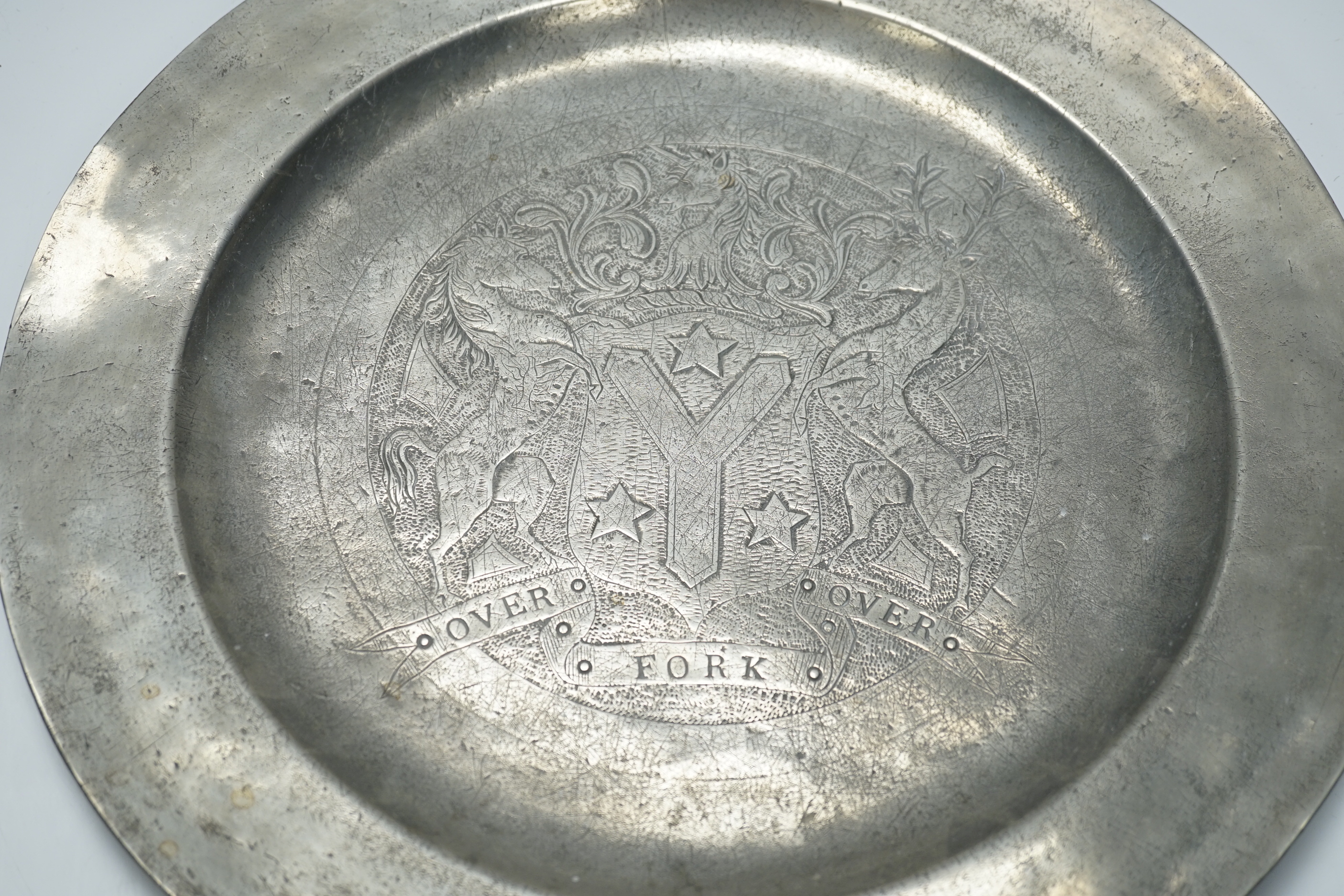 An 18th century pewter armorial charger, 38cm diameter